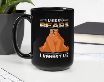 Puede incluir: Taza de cerámica negra con un gráfico de un oso con gafas de sol y el texto "Me gustan los osos grandes y no puedo mentir".