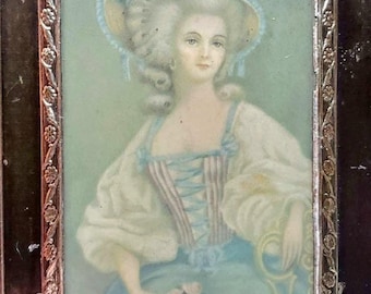 May include: A framed portrait of a woman in a white dress and a blue hat with flowers. The portrait is set against a light blue background.