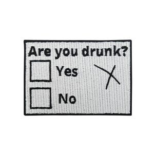 May include: White rectangular patch with a black border. Text reads "Are you drunk?" with check boxes for "Yes" and "No". A black "X" marks the "Yes" box.