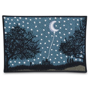May include: Embroidered patch with a blue background and white stars. The patch features a crescent moon and two black trees with a silhouette of a town in the distance.