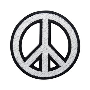 May include: A white peace sign with a black outline. The peace sign is a symbol of peace and love.