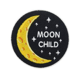May include: Round patch with a black background featuring a yellow crescent moon and white stars. The words "MOON CHILD" are in white, centered below the stars. The patch has a white border.