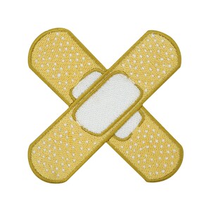 Könnte beinhalten: Ein gelber Stoffverband mit einer weißen Mitte in Form eines Kreuzes.