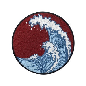 May include: Embroidered patch of a blue wave crashing over a red background. The wave is stylized and has white foam.
