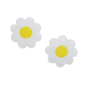 May include: Two white embroidered daisy patches with yellow centers.