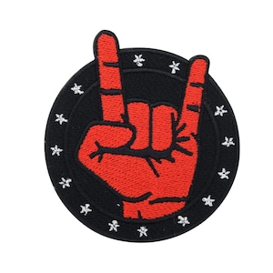 May include: Red embroidered hand making the rock and roll sign, surrounded by a black circle with white stars.