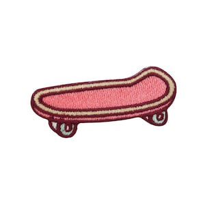 May include: A pink and brown embroidered skateboard patch with white wheels.