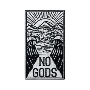 May include: Black and white embroidered patch featuring a mountain scene and the words "NO GODS" in a vintage style.