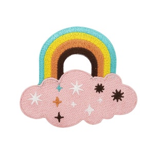 May include: Embroidered patch showing a rainbow above a pink cloud. The rainbow has bands of blue, yellow, orange, and brown. The cloud is decorated with white, brown, and blue stars. Ideal for adding to clothing or accessories.