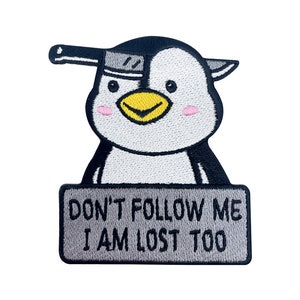 May include: Embroidered iron-on patch featuring a cartoon penguin wearing a knife on its head and holding a sign that reads "Don't follow me, I am lost too."