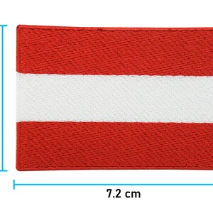 May include: A red, white, and red embroidered patch of the Austrian flag. The patch measures 7.2 inches by 5 inches.