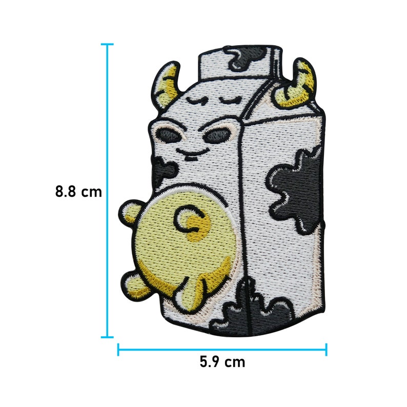 May include: A white and black cartoon milk carton with a cow's face and a yellow udder. The carton is 5.9 cm wide and 8.8 cm tall.