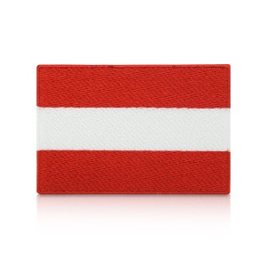 May include: A red and white embroidered patch with the flag of Austria. The patch is rectangular and has a white stripe in the middle.
