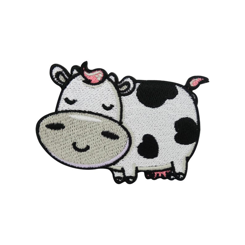 May include: Embroidered patch of a cartoon cow with a smiling face. The cow has a white body with black spots, a grey snout, and pink accents on its ears and tail. The patch is designed for application on clothing or accessories.