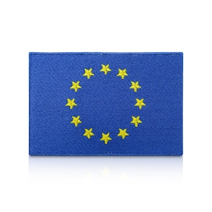 May include: A rectangular blue patch displaying the flag of the European Union. The flag shows a circle of twelve yellow stars on a blue field. The patch is made of fabric with a stitched border.