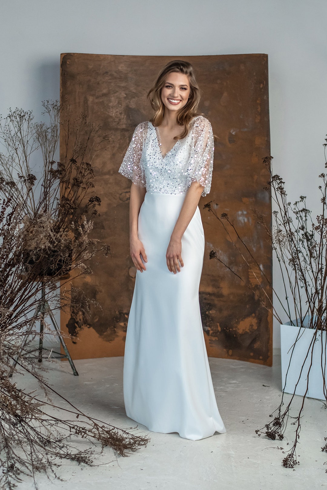ethnovog women's sequinned embellished layered bridal maxi dress reviews Sequin Cape Top, Modern Minimalist Wedding Dress, V Shaped Dress, Sparkly Gown stitched sequin and bead embellishment cascading from neckline to hem Elegant round neckline complemented by long sleeves for sophisticated coverage Graceful blouson bodice creating a flattering silhouette Floor Nude Embellished And Beaded Strappy