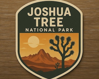 May include: A sticker featuring a desert landscape with a Joshua tree, mountains, and a setting sun. The text "JOSHUA TREE NATIONAL PARK" is at the top in white letters against a dark green background.