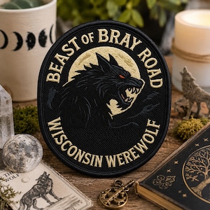 May include: Black embroidered patch with gold text and a snarling werewolf design. The patch reads "BEAST OF BRAY ROAD WISCONSIN WEREWOLF". The werewolf is set against a gold moon background.