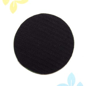 May include: Black round fabric patch with a hook and loop fastener on the back.