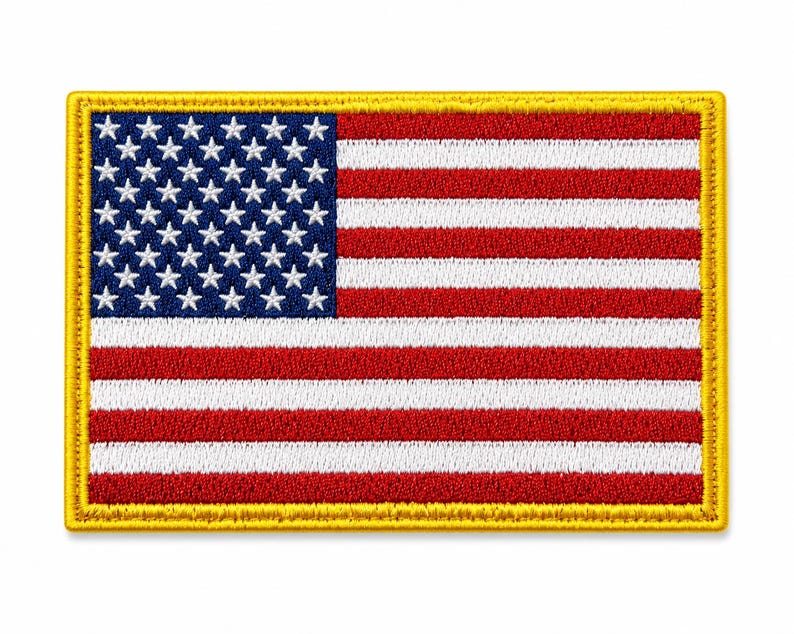 May include: A rectangular embroidered patch featuring the United States flag with a blue canton containing white stars and alternating red and white horizontal stripes, all bordered by a thick, solid yellow stitched edge on a white background.