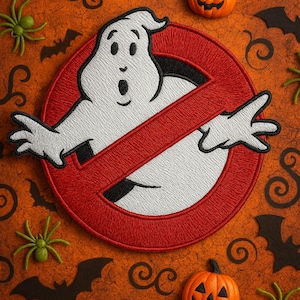 May include: Embroidered patch featuring the Ghostbusters logo with a white ghost inside a red circle with a red slash. The background is orange with Halloween-themed decorations, including pumpkins, bats, spiders, and swirls.