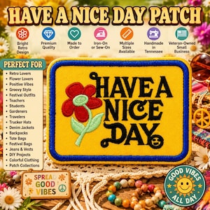 May include: A rectangular embroidered patch with a yellow background and a thick blue border. The patch features a red flower with a light green stem and leaves, alongside the black embroidered text "HAVE A NICE DAY" with a smiley face.
