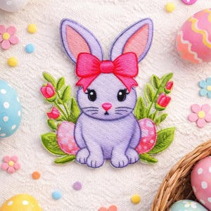 May include: A lavender bunny patch with a pink bow, surrounded by Easter eggs, flowers, and a butterfly. The patch is embroidered with a cute bunny design, perfect for Easter crafts and decorations.