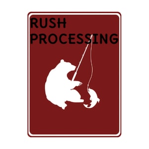 May include: A red sign with white text that reads "RUSH PROCESSING". A white silhouette of a bear fishing is depicted on the sign.
