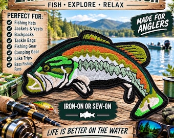 May include: An embroidered patch shaped like a largemouth bass with green, orange, and white thread details. The patch features a black border and is designed for iron-on or sew-on application. The design depicts the fish in a swimming pose.