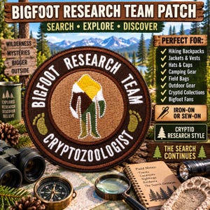 May include: A circular embroidered patch featuring a brown border with the text BIGFOOT RESEARCH TEAM CRYPTOZOOLOGIST and a central graphic of a stylized figure in yellow, brown, and green, flanked by two yellow embroidered footprints.
