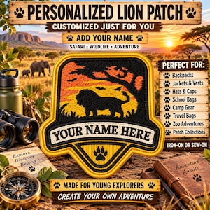 May include: A shield-shaped embroidered patch featuring a black lion silhouette against an orange and yellow sunset background. The patch includes a white banner with the text YOUR NAME HERE and a black paw print icon at the bottom.