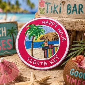 May include: A circular embroidered patch with a bright pink border featuring a tropical beach scene with a palm tree, a thatched-roof tiki bar, and the white embroidered text Happy Hour Siesta Key centered within the circular design.