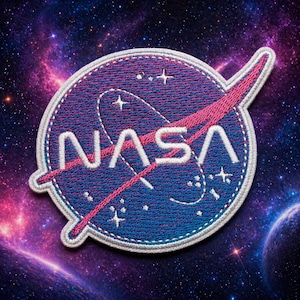 May include: Embroidered NASA patch featuring the iconic logo with a blue background, white text, and a pink swoosh. The patch is surrounded by a white border and set against a cosmic background with stars and galaxies.