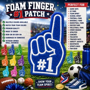 Op de afbeelding: Een blauwe schuimrubberen vinger-patch met witte geborduurde rand en de tekst #1 in het wit. De patch wordt getoond naast diverse sportartikelen, waaronder een voetbal, een American football, een basketbal, een medaille en een blauwe waterfles.
