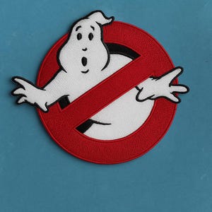 May include: Embroidered patch featuring the Ghostbusters logo. The design includes a white ghost figure inside a red circle with a red slash through it. The patch is on a blue background.