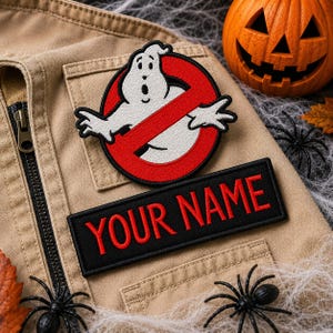 May include: A tan vest featuring a circular embroidered patch of a white ghost inside a red circle with a diagonal line, and a rectangular black embroidered patch below it with the red text YOUR NAME stitched in a bold, sans-serif font.