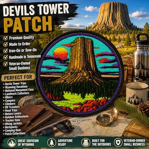 May include: A circular embroidered patch featuring a vibrant depiction of Devils Tower in Wyoming. The design showcases a golden-brown rock formation against a bright turquoise sky with a setting orange sun, purple clouds, and green pine trees.
