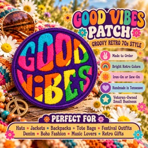 May include: A circular embroidered patch featuring the text GOOD VIBES in multi-colored letters including pink, orange, yellow, green, and blue against a dark purple background. The patch has a stitched border and a textured fabric surface.