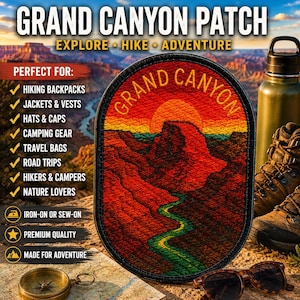 May include: An oval embroidered patch featuring a Grand Canyon landscape with a red sun, orange sky, dark red canyon walls, and a green river. The text GRAND CANYON is stitched in yellow at the top. The patch has a black border and is iron-on or sew-on.