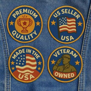 May include: Four round embroidered patches with patriotic themes. The patches are blue, gold, and red. One patch says "Premium Quality" with a trophy. Another says "US Seller USA" with a flag. One says "Made in the USA". The last says "Veteran Owned".