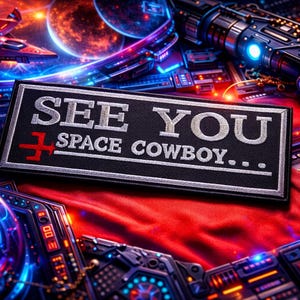 May include: A black rectangular patch with the text "SEE YOU SPACE COWBOY..." in white, with a red cross symbol. The patch is set against a futuristic, space-themed background with planets, a spaceship, and glowing neon lights.