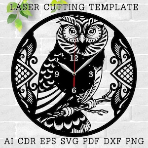 May include: Black and white laser cut template of an owl with clock hands and numbers. The owl is perched on a branch with intricate floral designs around it.  The template is for a clock design.