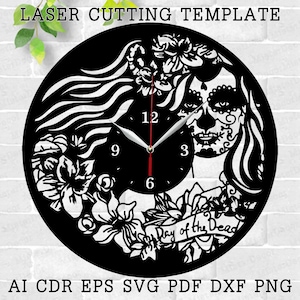 May include: Black and white laser cut clock design featuring a woman with a sugar skull face, flowers, and the text "Day of the Dead".