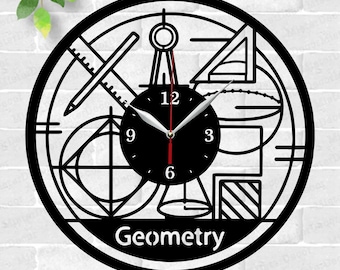 May include: Black and white geometric clock design with a clock face in the center. The clock face has black hands and white numbers. The design includes a compass, ruler, protractor, and other geometric shapes. The text "Geometry" is at the bottom of the design.