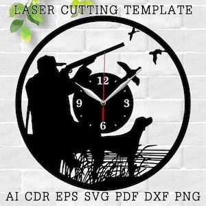 May include: Black and white silhouette of a hunter with a gun, a dog, and birds, with a clock face in the center. The clock face has Roman numerals and a silver hand. The design is a laser cutting template.