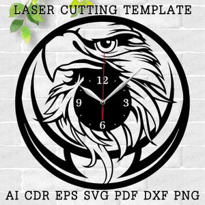 May include: Black and white laser cut clock template featuring an eagle head design. The clock face is visible with numbers 12, 3, 6, and 9.  AI CDR EPS SVG PDF DXF PNG.