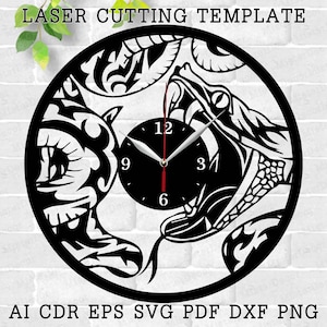 May include: Black and white laser cut clock design featuring two snakes intertwined with a clock face in the center. The clock face has Roman numerals and black hands. The design is suitable for use as a wall clock.