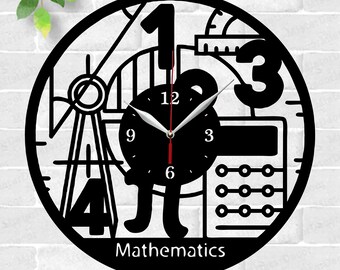 May include: Black and white laser cut clock design featuring mathematical symbols, numbers, and a compass. The clock face reads "Mathematics".