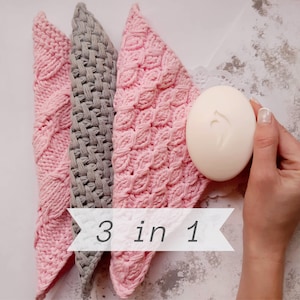 May include: Three knitted washcloths, two pink and one gray, with the text "3 in 1" on a white background.