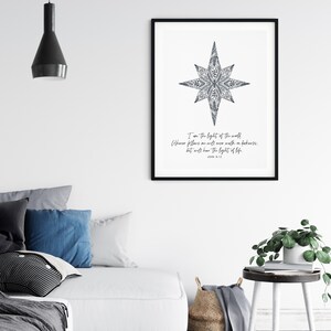 May include: A black and white printable wall art print with a star design and the text "I am the light of the world. Whoever follows me will never walk in darkness, but will have the light of life. John 8:12"